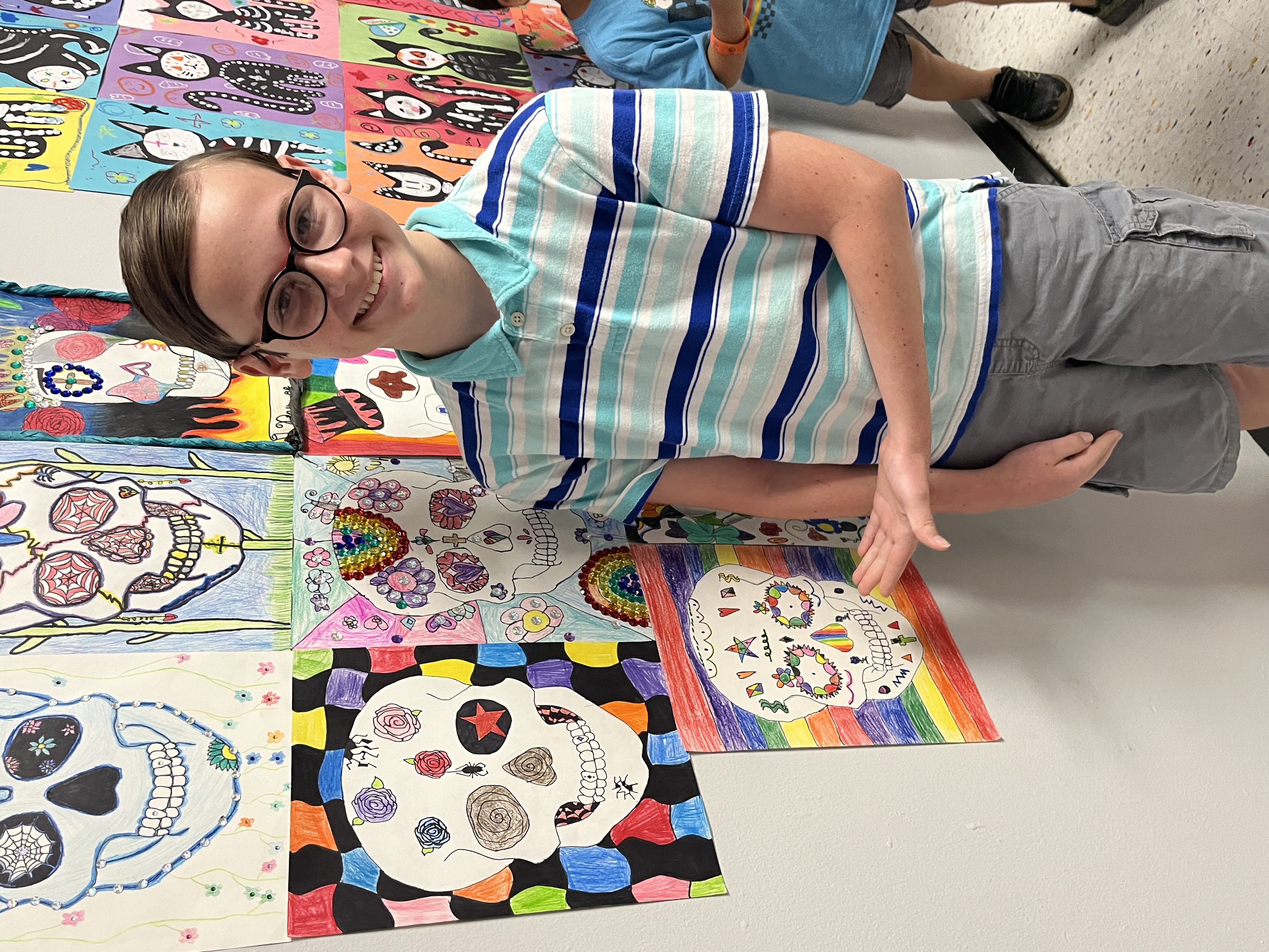 Children’s Health patient Aiden poses alongside his artwork.